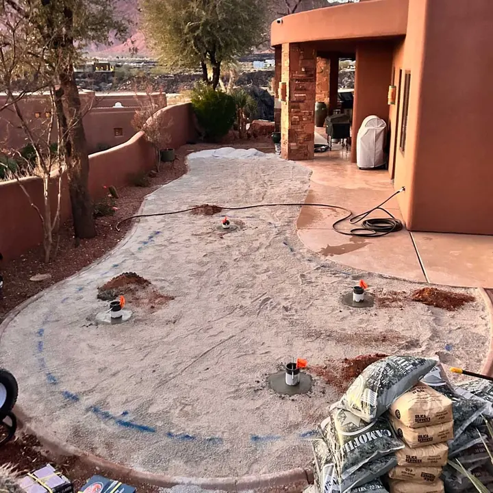 Before: a compacted base with the cups set and the green outline painted, ready for turf